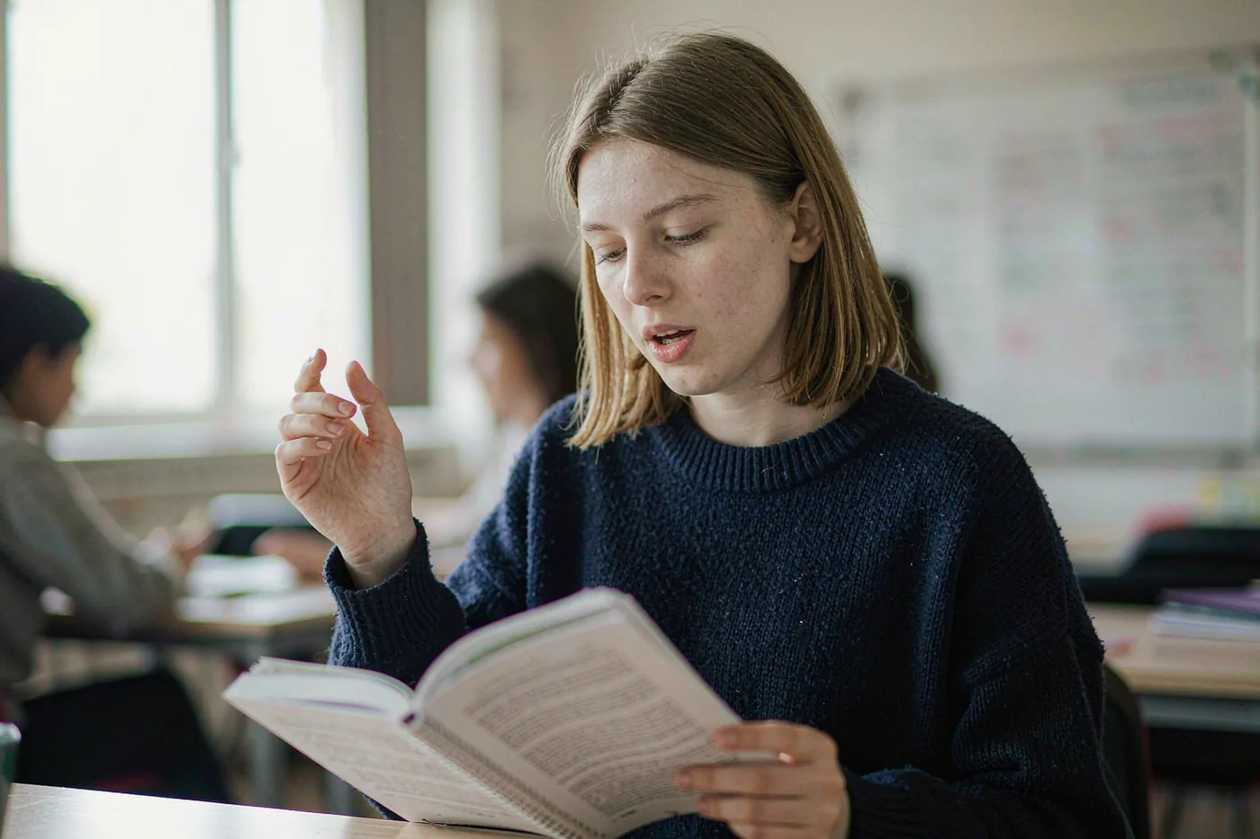 A foreign exchange student practising Mandarin pronunciation in a Chinese classroom