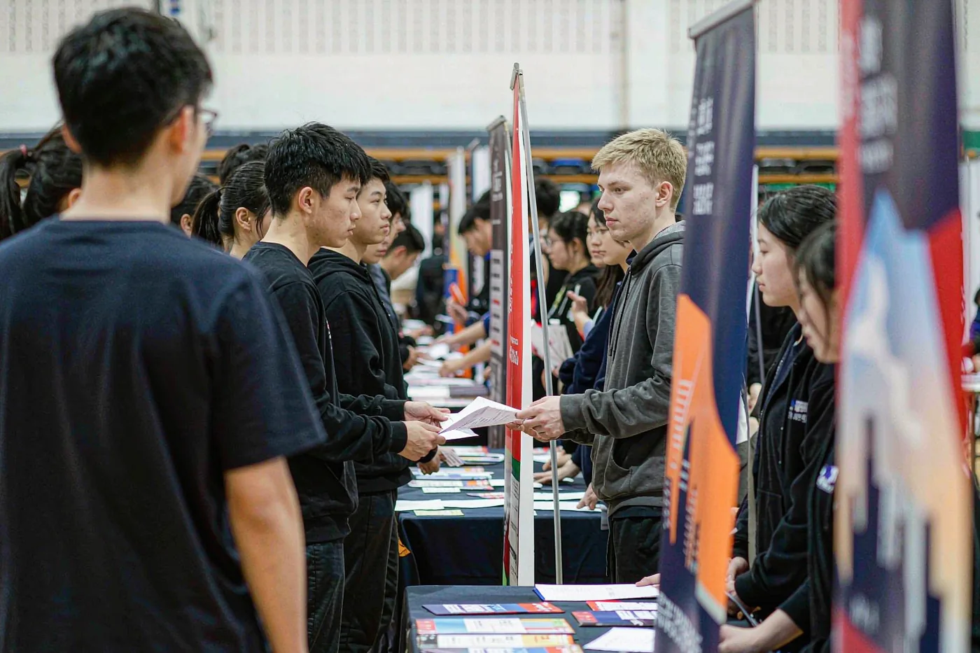 Students queueing at employer booths at a Chinese university job fair