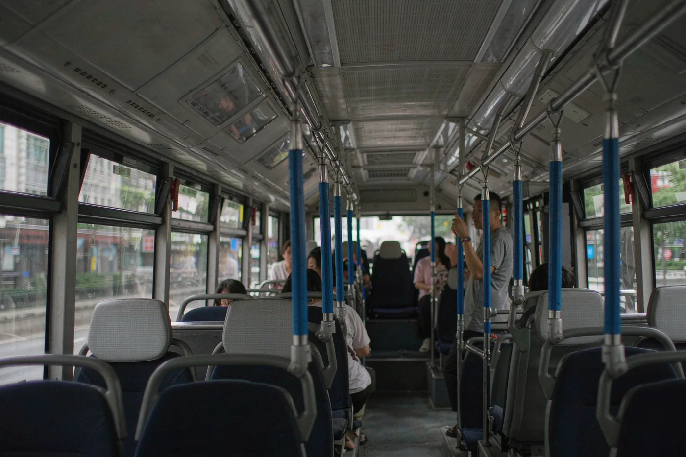 Interior of a city bus in China with seats and handrails